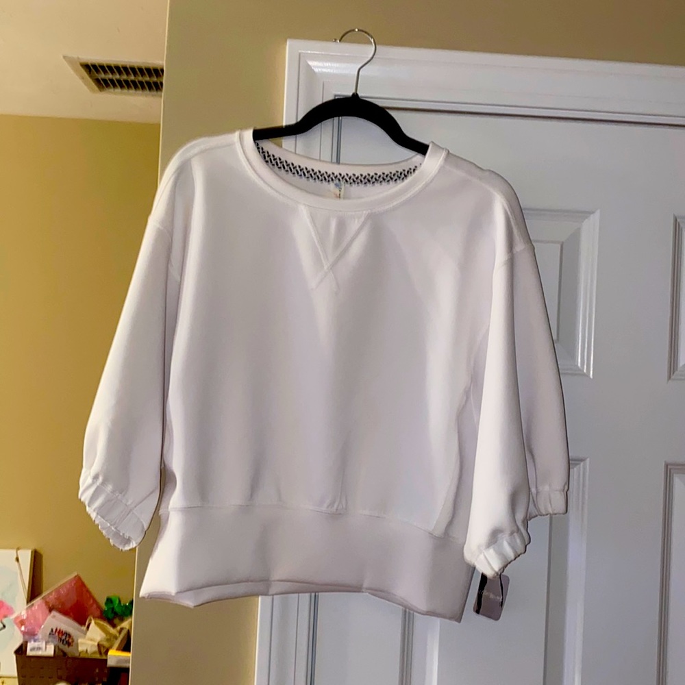 New w/ tags. Never been worn. Size small. Brand-Free People. 3/4 Sleeved Top.